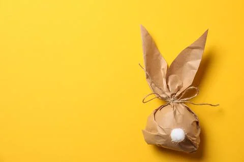 Creative Easter bunny gift bag on color background, top view with space for t Foto stock