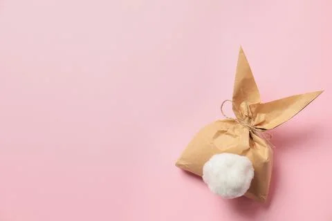 Creative Easter bunny gift bag on color background, top view with space for t Foto stock