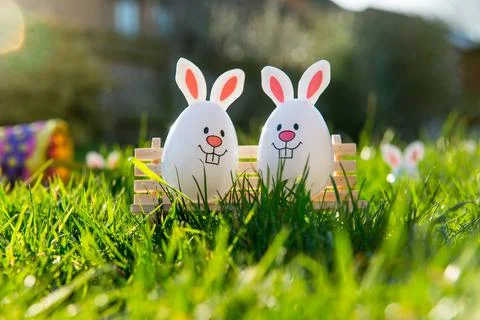 Creative Easter composition of Funny Easter eggs with bunny ears sitting on Stock Photos