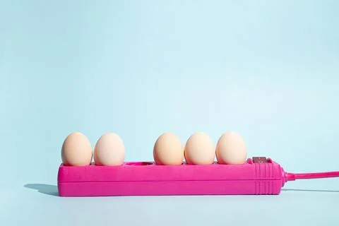 Creative Easter concept with eggs plugs in with extension pink cable and shad Stock Photos