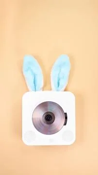 Creative Easter Design Portable CD Player with Bunny Ears on a Pastel Background Stock Photos