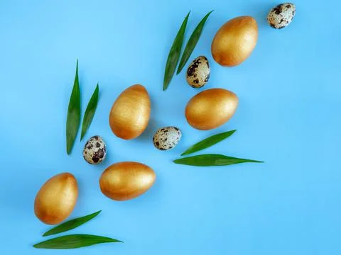 Creative Easter diagonal composition made from golden wooden eggs, quail eggs Stock Photos