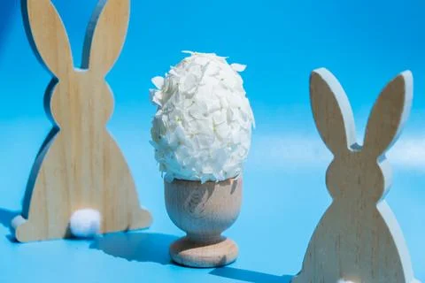 Creative Easter egg shape made of white lilac spring petals flowers. Responsible Stock Photos