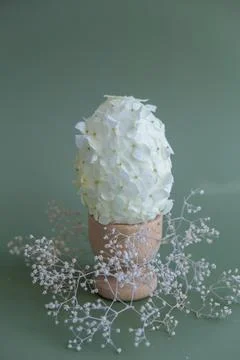 Creative Easter egg shape made of white lilac spring petals flowers. Responsible Stock Photos