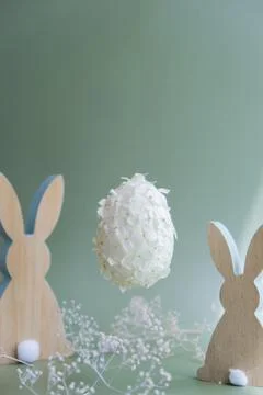 Creative Easter egg shape made of white lilac spring petals flowers levitating Stock Photos