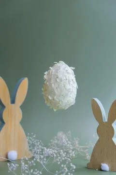Creative Easter egg shape made of white lilac spring petals flowers levitating Stock Photos