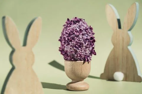 Creative Easter egg shape made of lilac spring petals flowers. Eco-friendly Stock Photos