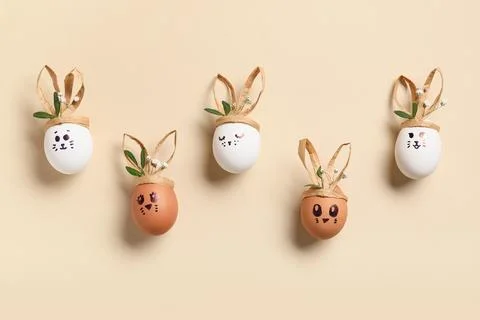 Creative Easter eggs on beige background Stock Photos