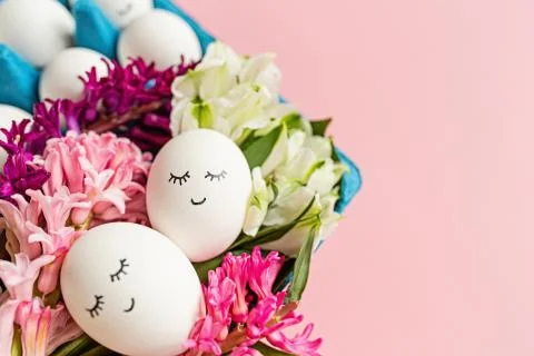 Creative easter eggs with cute face and sleepy eyes and hyacinth flower on pa Stock-Fotos