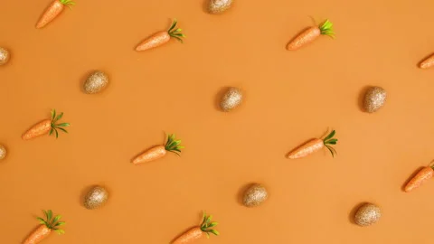 Creative Easter pattern with moving golden eggs and glitter carrots. Stop motion Stock Footage 150276799