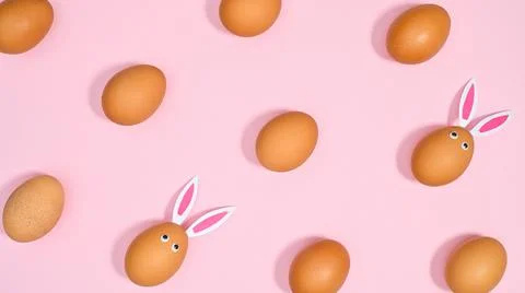 Creative Easter pattern with natural creative eggs on pastel pink background. Stock Photos
