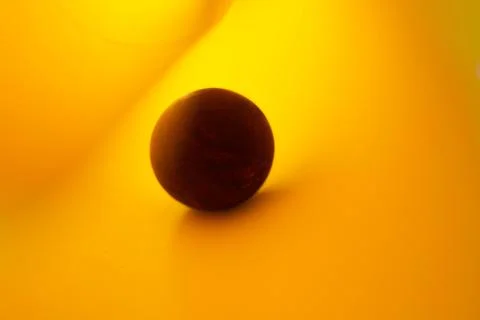 Creative Easter photo, purple egg on a yellow background. Space for text. Stock Photos