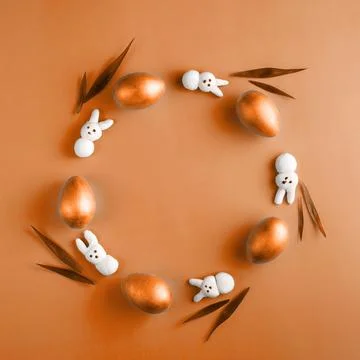 Creative Easter wreath made from wooden eggs, marshmallow bunny and grass on Stock Photos