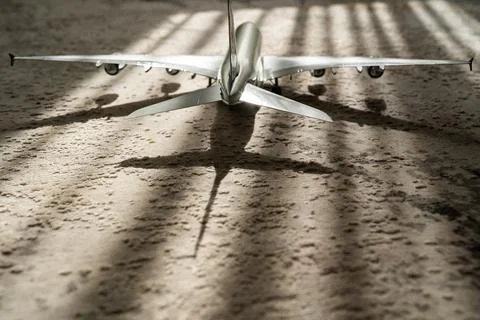 Creative effect with sun light beam, airplane aircraft toy on grey background Stock Photos