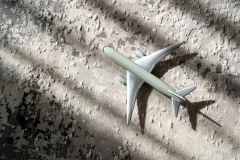 Creative effect with sun light beam, airplane aircraft toy on grey background Stock Photos