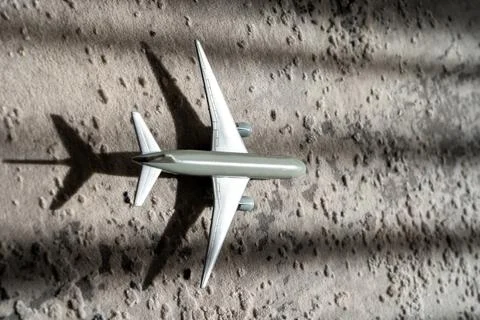 Creative effect with sun light beam, airplane aircraft toy on grey background Stock Photos