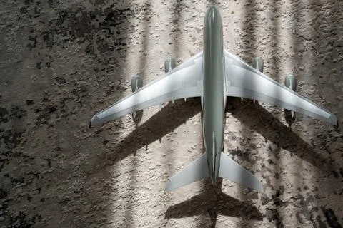 Creative effect with sun light beam, airplane aircraft toy on grey background Stock-Fotos