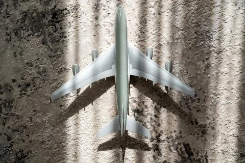 Creative effect with sun light beam, airplane aircraft toy on grey background Stock Photos