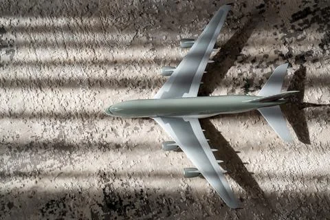 Creative effect with sun light beam, airplane aircraft toy on grey background Stock Photos