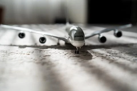 Creative effect with sun light beam, airplane aircraft toy on grey background Stock Photos