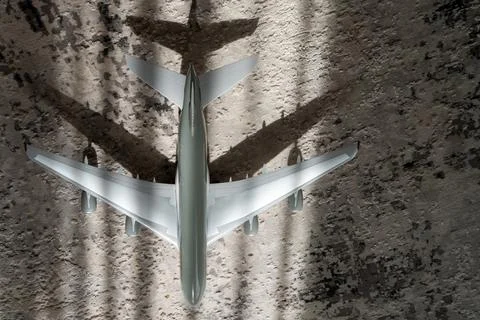 Creative effect with sun light beam, airplane aircraft toy on grey Stock Photos