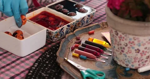 Creative egg painting process with hidden Easter eggs while exploring unique Stock Footage 306067555