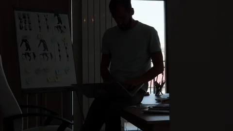 Creative emplyee taking notes while looking at design sheets Stock Footage 113875611