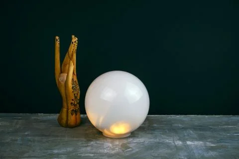 Creative esoteric still life with a ball of predictions and wooden female han Stock Photos