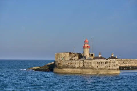 Creative evening view of red East Pier lighthouse in Dun Laoghaire harbor Stock Photos