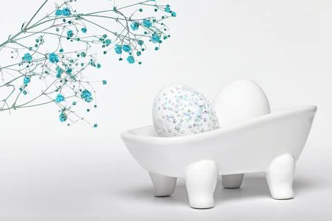 Creative experiment, composition of an egg decorated with sparkles lie in cer Stock Photos