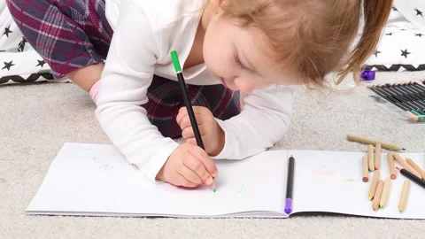 Creative exploration unfolds as child draws inside cozy tent space 스톡 동영상 295355309