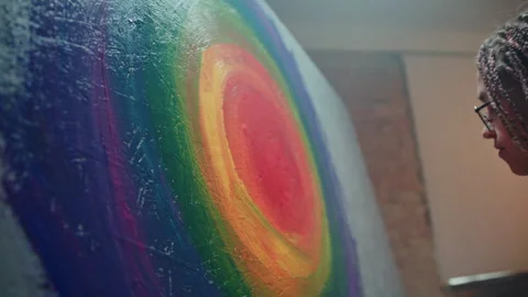 Creative Expression: Artist Paints Multicolored Circles on LGBT-Inspired Canvas Video stock 250816802
