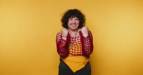 Creative expression through fun gestures in a vibrant studio setting with b.. Stock Footage 313273931