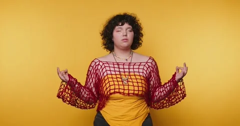 Creative expression through yoga poses in bright yellow backdrop Stock Footage 313951580