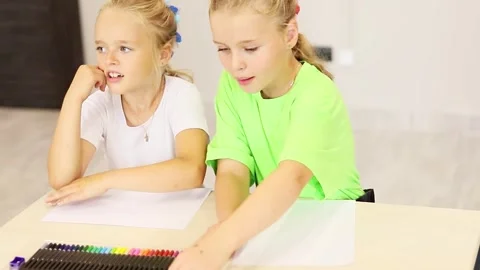 Creative expressions of two children while coloring in a bright space Stock-Footage 296332247
