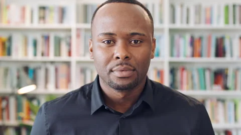 Creative, face and man with pride in library, knowledge or serious for Stock Footage 336296825