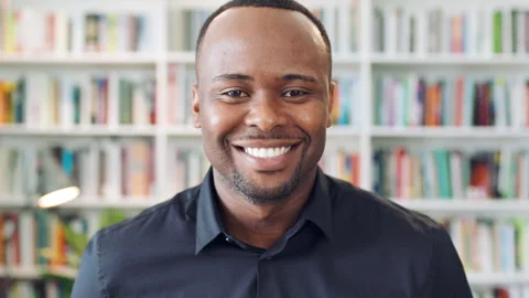 Creative, face and man with smile in library, knowledge and pride for publishing Stock Footage 336296612