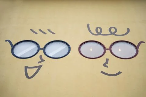 Creative face illustrations on yellow wall with window eyes Stock Illustration