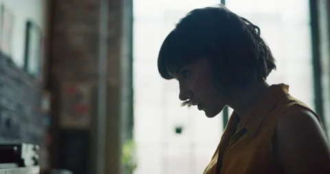 Creative female printer looking at letters for printmaking in interior art studi Stock-Footage 199456524