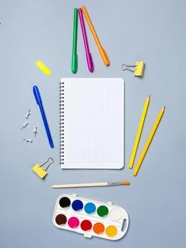 Creative flat design desktop mockup with empty notebook, stationery on blue b Stock Photos
