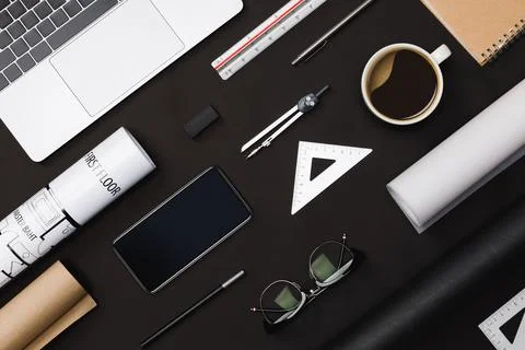 Creative flat lay of architects black table with roll blueprints, architect.. Stock Photos