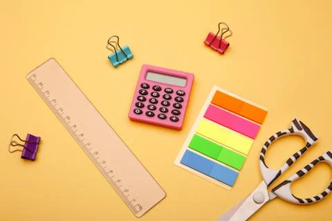 Creative flat lay. Back to school - school supplies on yellow background Stock Photos