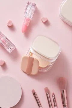 Creative flat lay background of a makeup set with an unlabeled water powder b Stock Photos