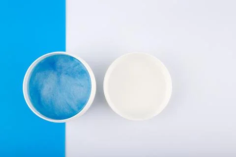 Creative flat lay with blue face or hair mask with sea minerals on blue and Stock Photos