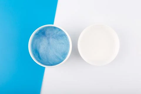 Creative flat lay with blue face or hair mask with sea minerals on blue and Stock Photos