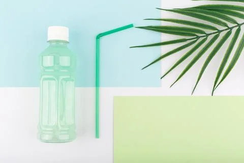 Creative flat lay with bottle with green detox drinks on colored background with Stock Photos