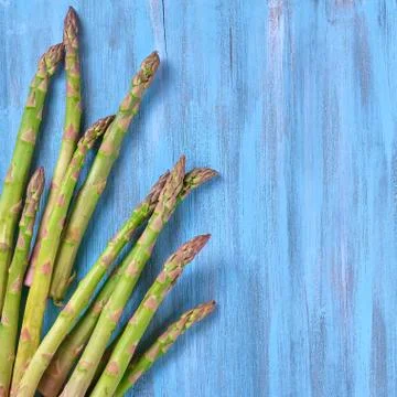 Creative flat lay with Bunch of fresh green Asparagus Stock Photos