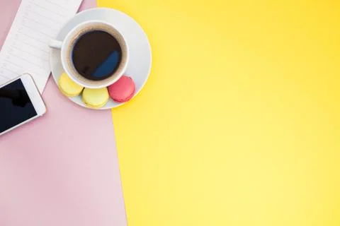 Creative flat lay with coffee cup and macaroons Stock Photos