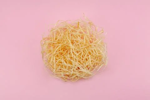 Creative flat lay concept. The love nest made of beige hay and one red heart Stock Photos