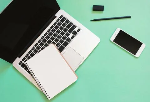 Creative flat lay design of workspace desk with laptop, blank notebook, sma.. Stock Photos